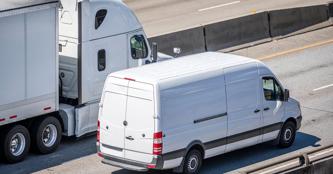 a-white-van-and-a-white-truck-on-the-road