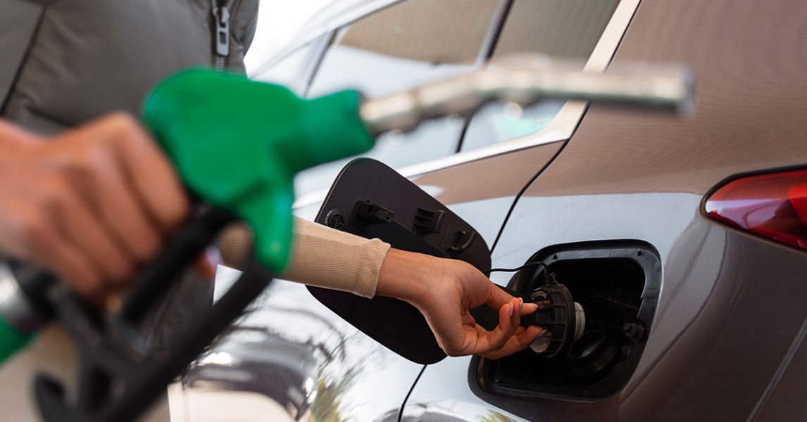 view-woman-with-car-gas-station